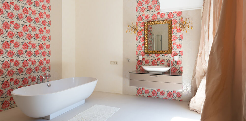 gold mirror in bathroom with pink floral wallpaper - bold maximalism style bathroom