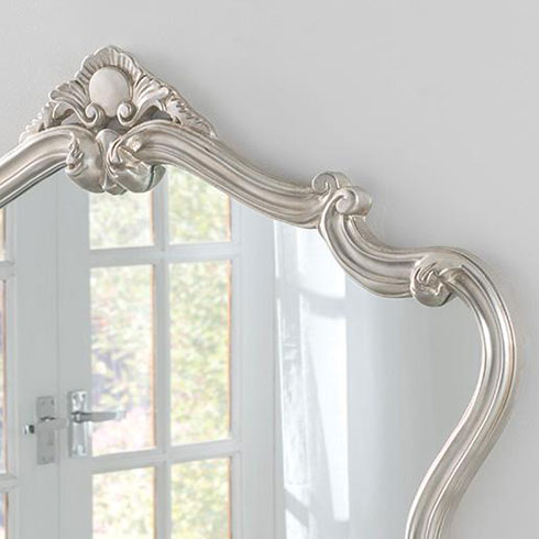 shaped silver crested baroque style mirror