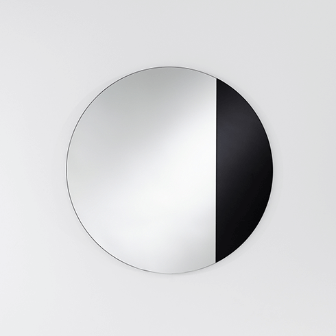 black round mirror with asymmetrical design
