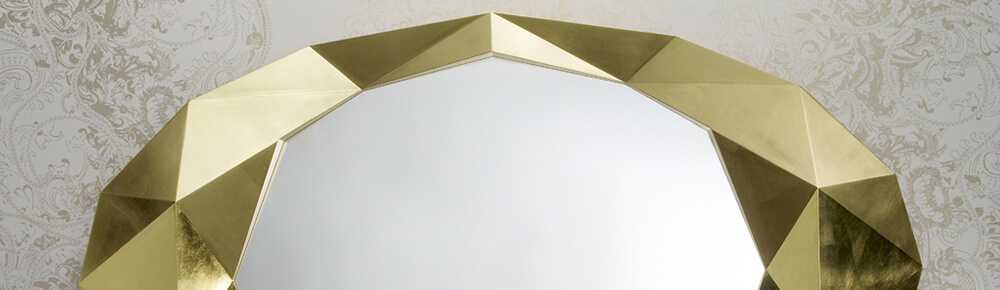 gold mirror hung on a wall