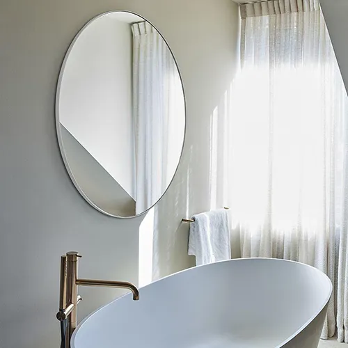 circular bathroom mirror over free standing bath