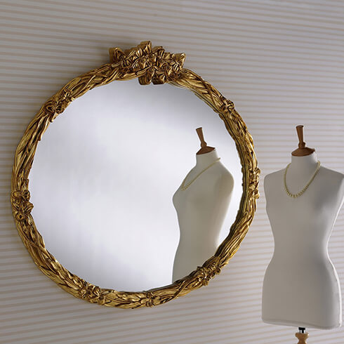 large oval ribbon texture gold framed mirror with mannequin