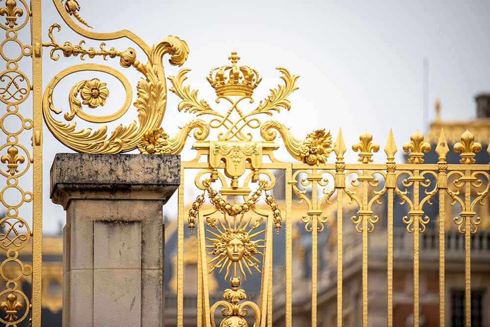 Palace of Versailles gates with a sunburst design