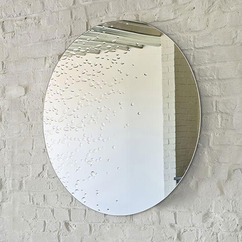round bathroom mirror with water bubble effect on white brick wall