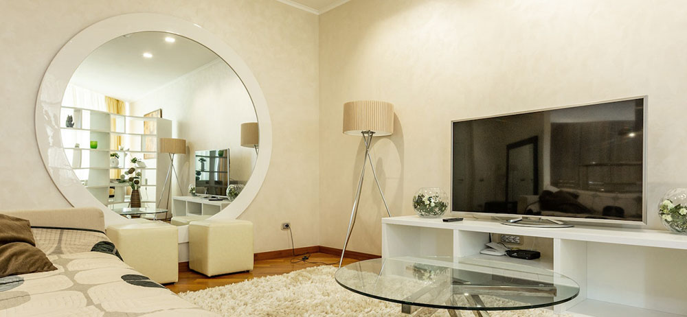 large round white framed mirror on living room wall